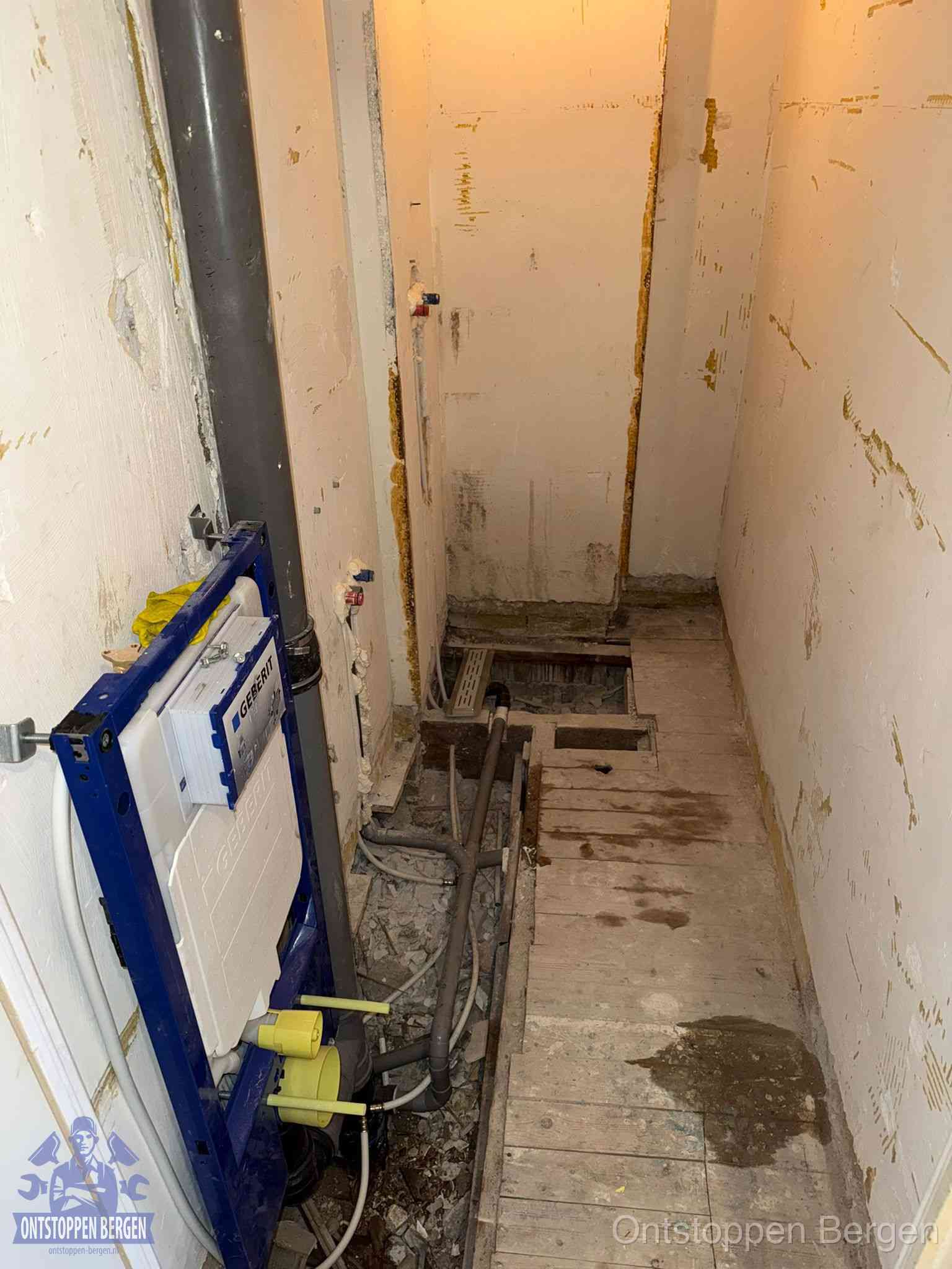 Een opgebroken toiletruimte tijdens renovatie met een Geberit inbouwreservoir en blootliggende oude afvoerleidingen, typisch voor oudere woningen in Bergen